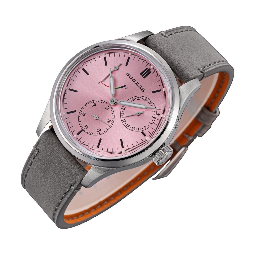 Sugess S458 pink dial power-reserve watch, grey suede strap, angled product view with orange lining, on black