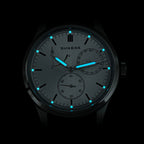 Sugess S458 silver sunburst dial glowing blue lume in the dark, applied markers and hands aglow, close-up