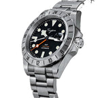 Sugess S463 GMT black dial watch, top-down angled view showing the date cyclops, steel bracelet, on black