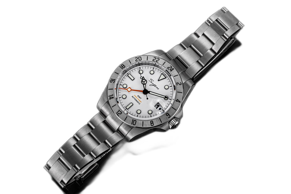 Sugess S463 white-dial GMT automatic watch, steel bracelet, dramatic reclined three-quarter angle on white