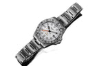 Sugess S463 white-dial GMT automatic watch, steel bracelet, dramatic reclined three-quarter angle on white