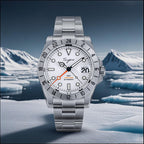 Sugess S463 white-dial GMT automatic watch, steel bracelet, staged before a snowy arctic iceberg scene