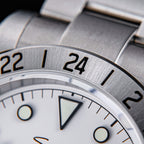 Sugess S463 macro of the fixed 24-hour engraved steel bezel showing 22, 24 and 2, steel oyster bracelet