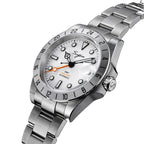 Sugess S463 GMT white dial watch, top-down angled view showing the date cyclops, steel bracelet, on black