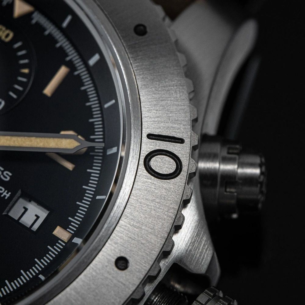 Sugess S464 brushed titanium countdown bezel and crown, extreme macro close-up on black