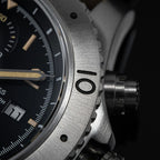 Sugess S464 brushed titanium countdown bezel and crown, extreme macro close-up on black