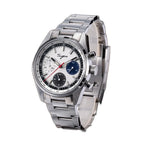 Sugess S465 chronograph, silver dial with blue and grey sub-dials, steel bracelet, front three-quarter on dark wood