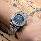 Sugess S466 dark mother-of-pearl dial sport watch worn on the wrist, integrated steel bracelet