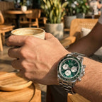 Sugess S473 Chrono Racing green dial automatic chronograph worn on the wrist at a cafe, steel bracelet