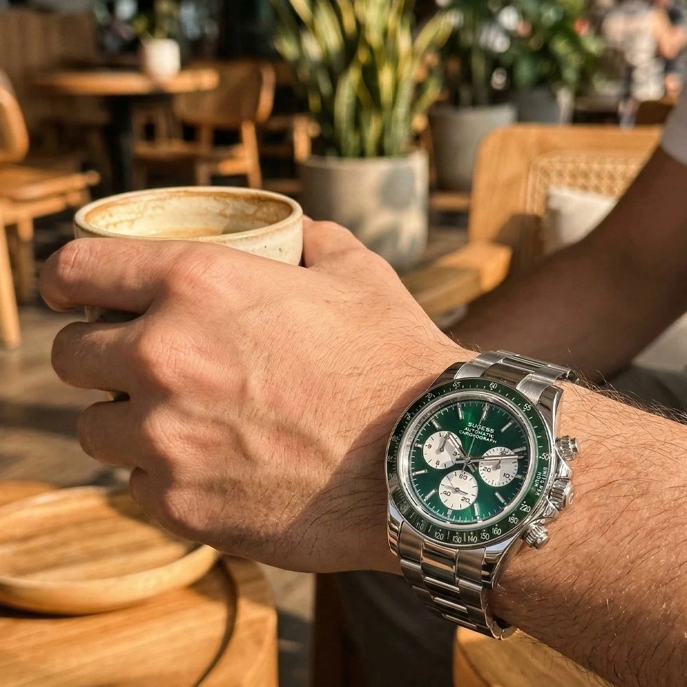 Sugess S473 Chrono Racing green dial automatic chronograph worn on the wrist at a cafe, steel bracelet