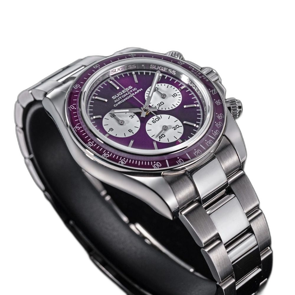 Sugess S473 Chrono Racing automatic chronograph, purple dial, steel bracelet, angled view over a grey surface