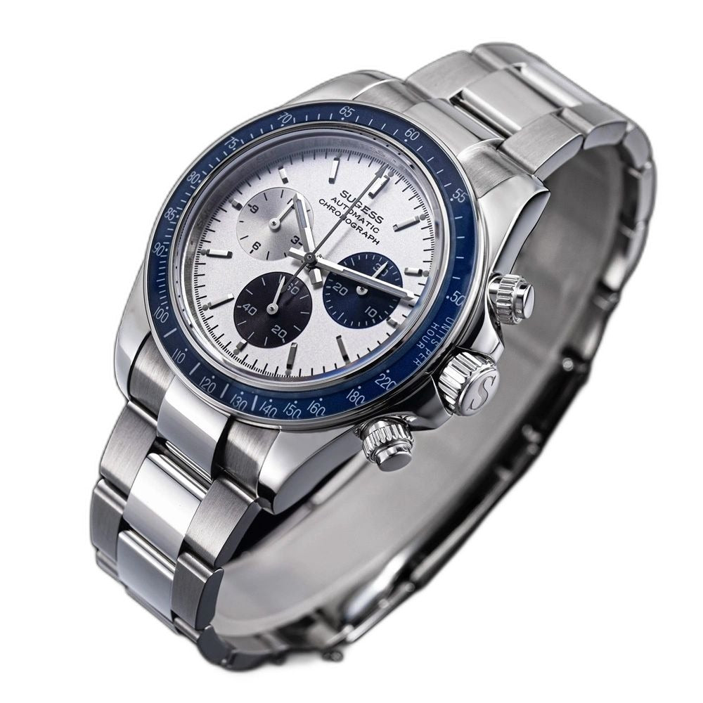 Sugess S473 Chrono Racing silver-white dial, blue bezel, S-engraved crown, steel bracelet, angled view on black