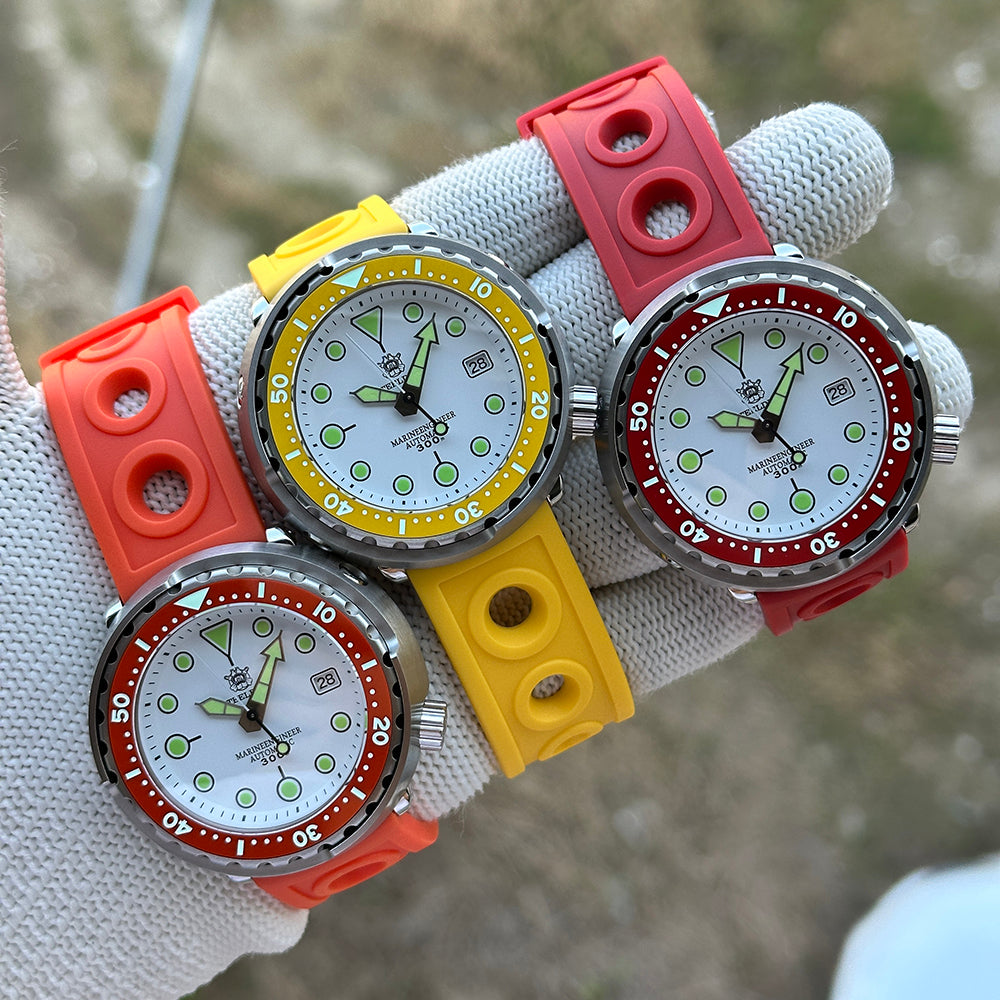 Three STEELDIVE SD1975N watches with orange, yellow and red bezels on matching rubber straps