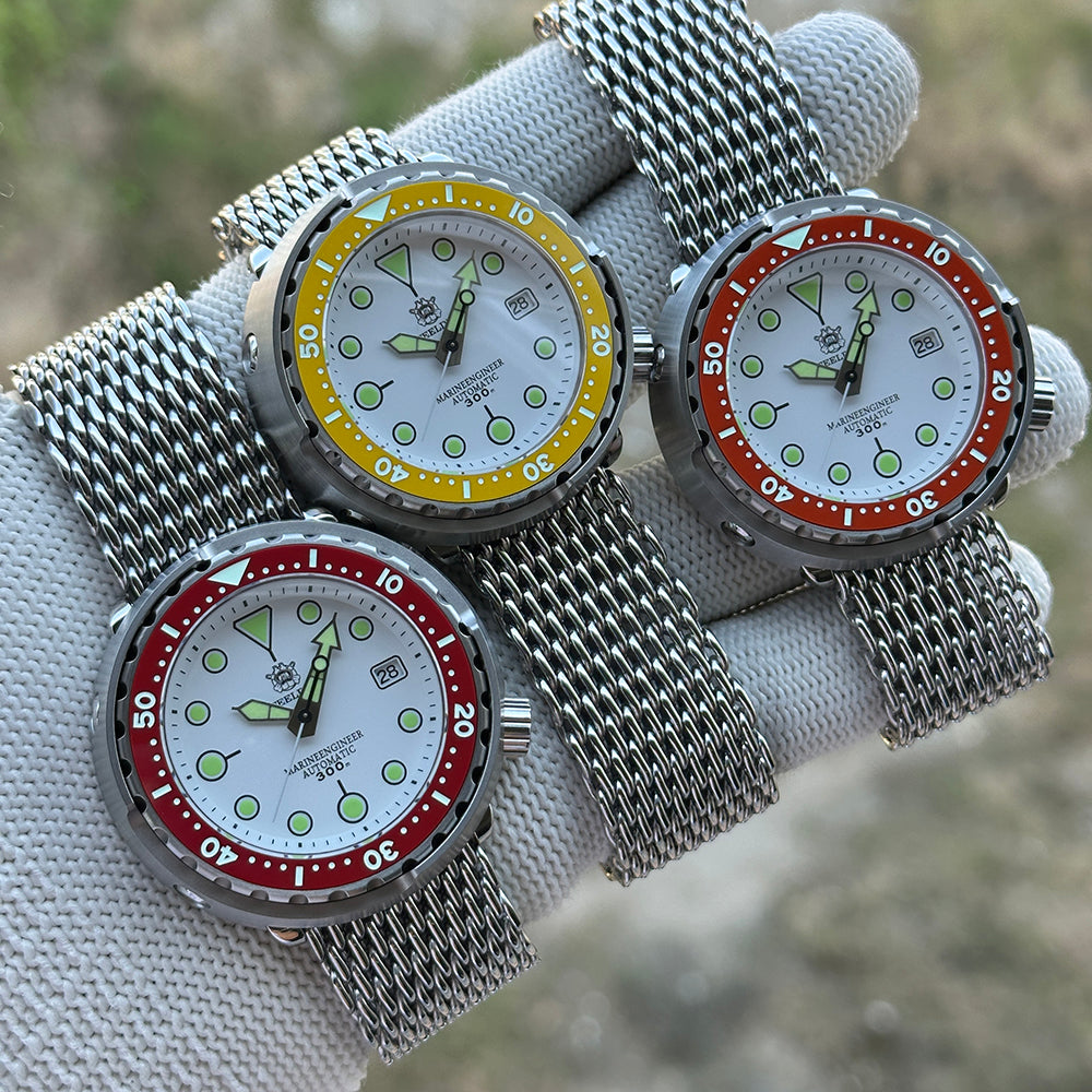 Three STEELDIVE SD1975N watches with yellow, orange and red bezels on steel mesh bracelets